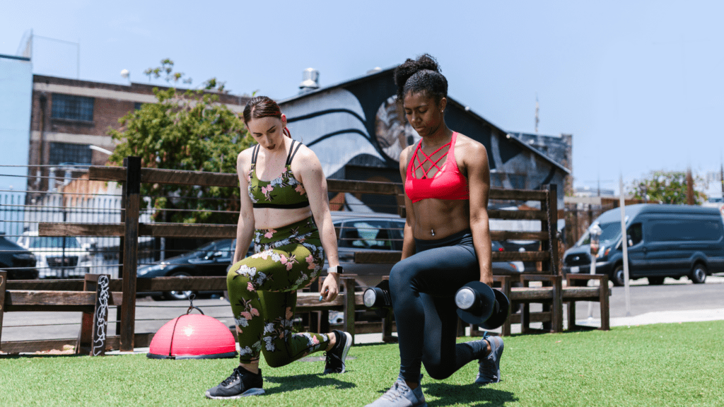 Two women engaging in bodyweight exercises, demonstrating the simplicity and accessibility of workouts for beginners.
