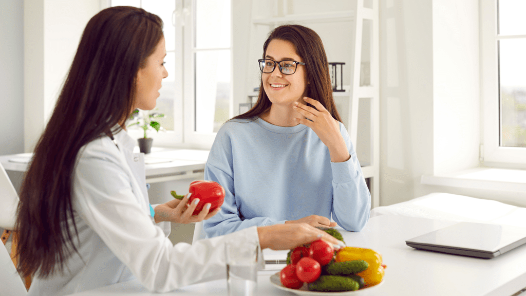Image of a nutritionist explaining concepts to a patient, illustrating 'The Science of Losing Weight'.