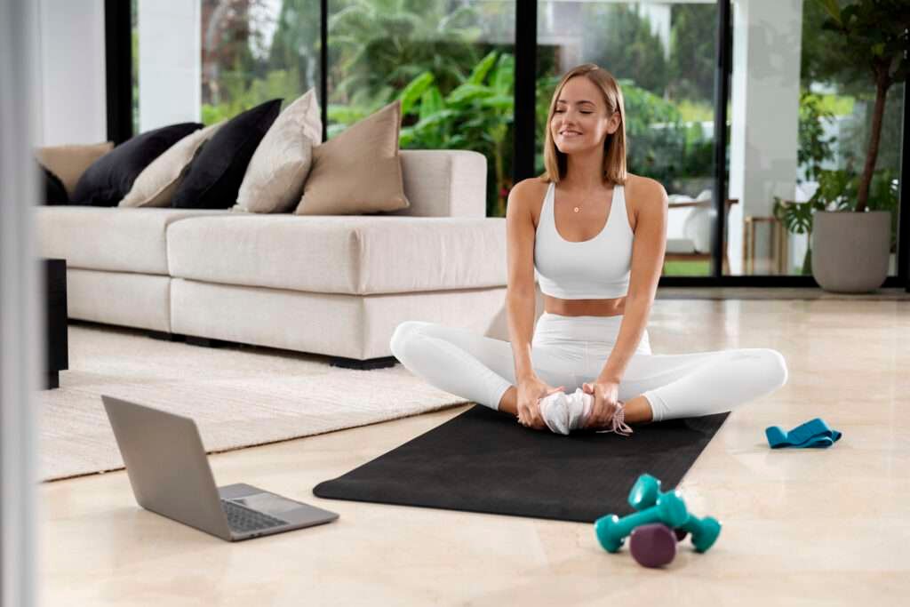 Image of a girl multitasking, working at her yoga mat while incorporating fitness exercises, highlighting the concept of achieving work-life balance with a focus on fitness.
