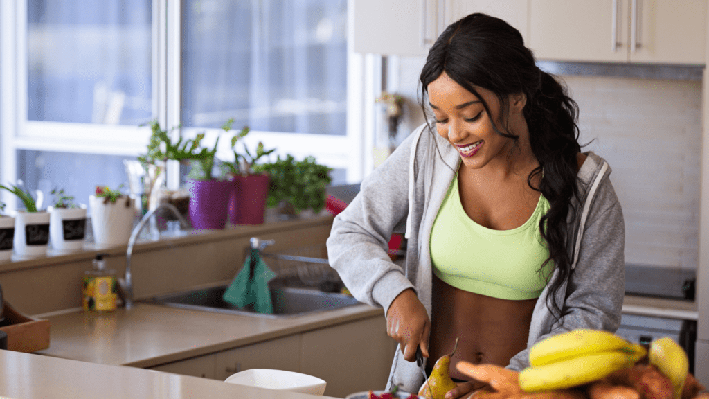 Image of a girl in the kitchen preparing a nutritious meal as part of her healthy lifestyle habits.