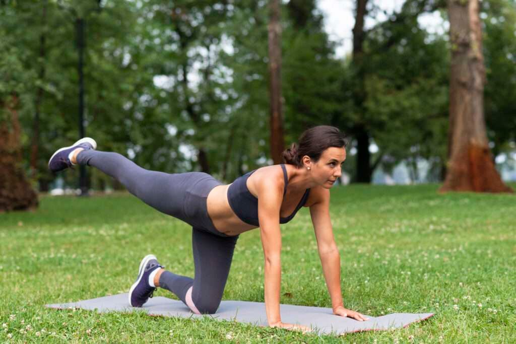 A women performing a warm-up exercise, preparing their muscles and joints for physical activity