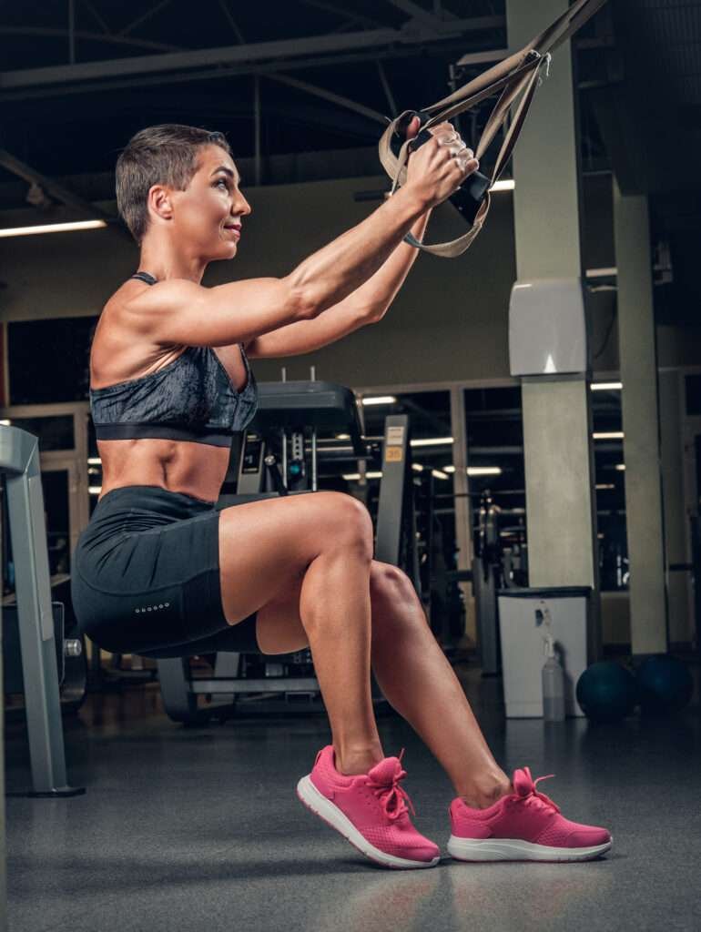 A muscular woman performing cable chest exercises in a gym, showcasing the effectiveness of the Master Cable Chest Workouts